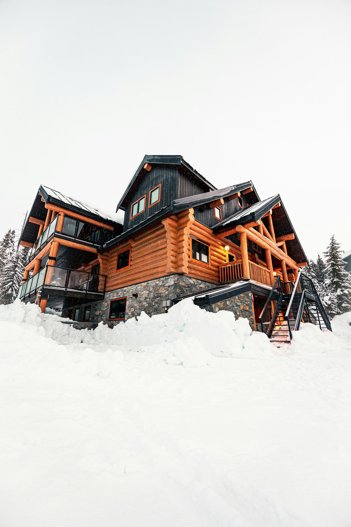 Large log cabin surrounded by deep snow